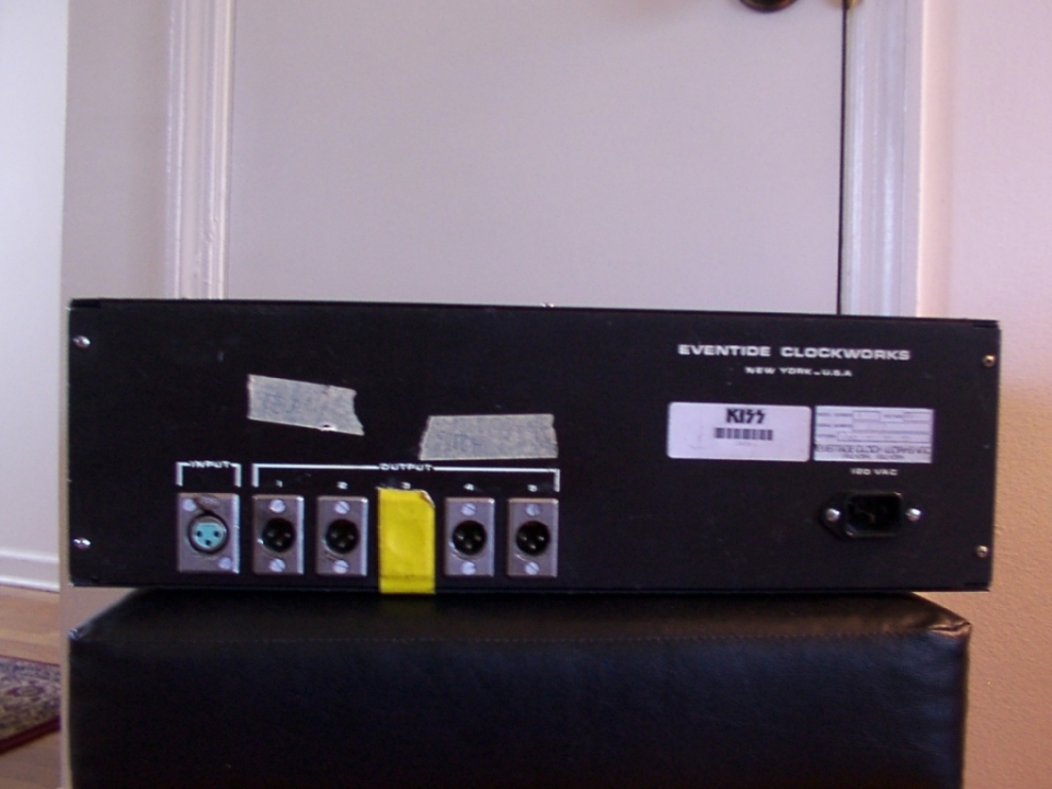 The writing on the tape above output xlrs 1 & 2 reads 'DELAY', and then 'PITCH' is written above output xlr 4. The yellow tape indicates unused output xlr 3. Output xlr 5 is another delay. KISS' inventory barcode sticker is next to the serial plate.